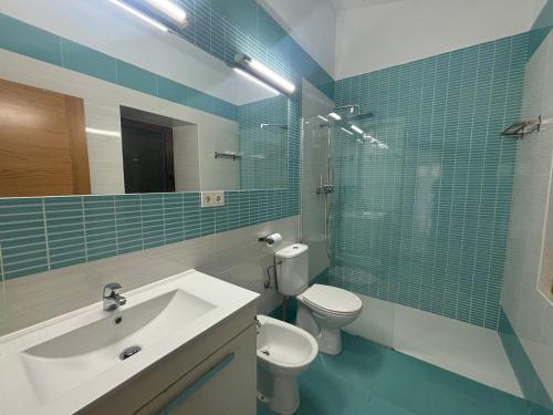 a bathroom with a sink and a toilet and a mirror at Mirador de Proacina - Senda del Oso 
