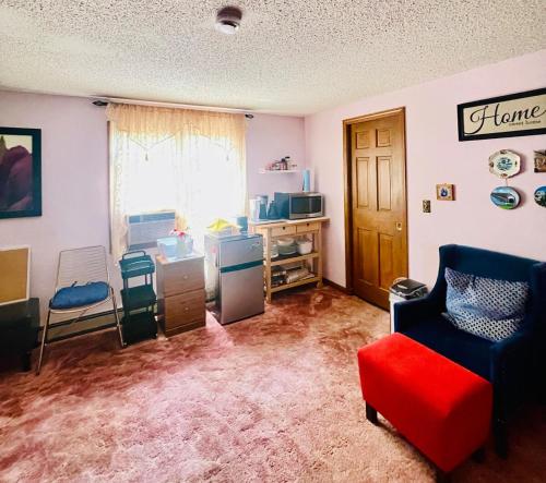 a living room with a couch and a chair at Cozy Loft in Amherst NY No Pet in Buffalo