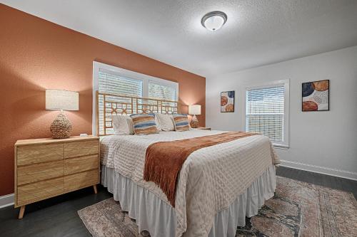 a bedroom with a large bed and two windows at Daydream on Elm St - Dream City Retreats in Arlington