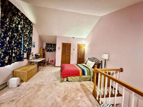 a bedroom with a bed and a desk in it at Cozy Loft in Amherst NY No Pet in Buffalo