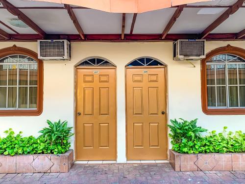 two doors on a house with two windows at Hotel Continental Plaza in San Miguel