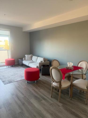 a living room with a table and chairs and a couch at Mollies Alpha in Langford