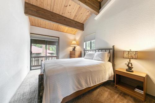 a bedroom with a bed and a window at Townhouse wLake View #254 at Donner Lake Village in Donner Lake Village