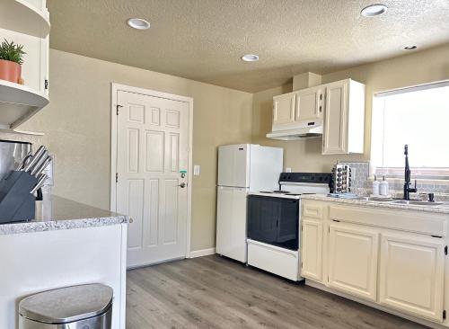 a kitchen with white appliances and a white door at Near Downtown- Kitchen-washerdryer-parking in Medford