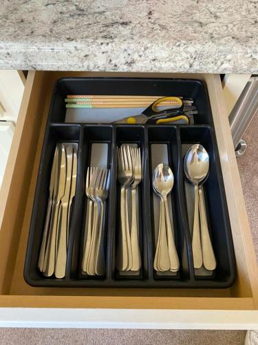 a tray of forks and spoons in a drawer at Near Downtown- Kitchen-washerdryer-parking in Medford