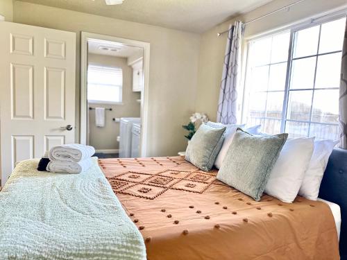 a bedroom with a bed with pillows and a window at Near Downtown- Kitchen-washerdryer-parking in Medford