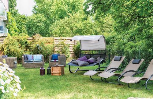 a yard with chairs and a gazebo at Leonardo Hotel Karlsruhe in Karlsruhe