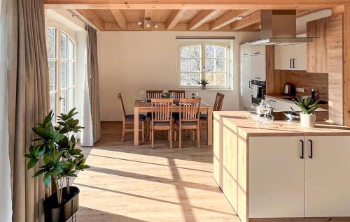 a kitchen and dining room with a table and chairs at Nice Apartment In Südharz With Sauna in Stolberg i. Harz