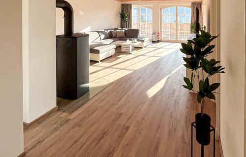 a living room with a wood floor and a fireplace at Nice Apartment In Südharz With Sauna in Stolberg i. Harz