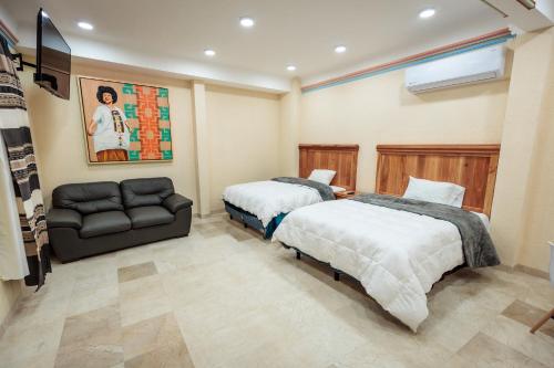 Postel nebo postele na pokoji v ubytování Casa Margarito Jalatlaco