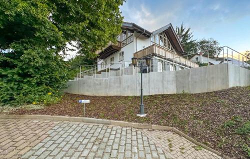 a house with a fence in front of it at Amazing Apartment In Südharz With Sauna in Stolberg i. Harz
