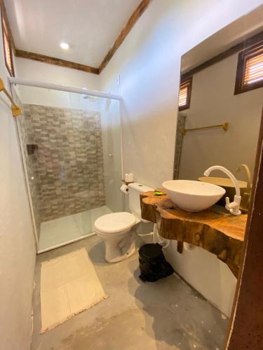 a bathroom with a sink and a toilet and a shower at Casa Nativa Tatajuba in Camocim