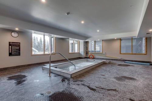 an empty room with a hot tub in the middle at Inspired Elegance at Tamarack Lodge in Canmore