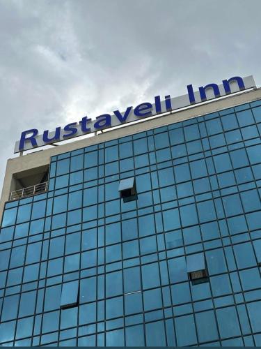 a sign on top of a building at Rustaveli Inn რუსთაველი ინნ in Rustavi