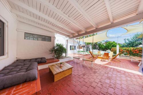 a living room with a couch and a table at Private 5br Pool Villa Modern Aruba Style in Piedra Plat