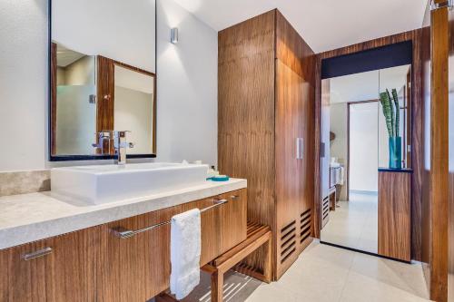 a bathroom with a sink and a mirror at Fiesta Americana Condesa Cancun - All Inclusive in Cancún