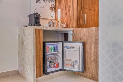 a refrigerator with its door open in a kitchen at Fiesta Americana Condesa Cancun - All Inclusive in Cancún