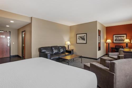 a hotel room with couches and a living room at Best Western Blairmore in Saskatoon