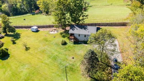 an aerial view of a house in a field at Little Pisgah Sunrise by AvantStay Mountain View in Fairview