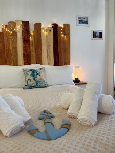 a bed with towels and flip flops on it at Apartment Due Mari Milano ZONA PORTELLO-FIERA FREE WI-FI in Milan