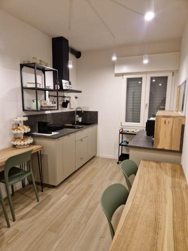 a kitchen with a table and a dining room at B&B Casa Tassoni in Maranello