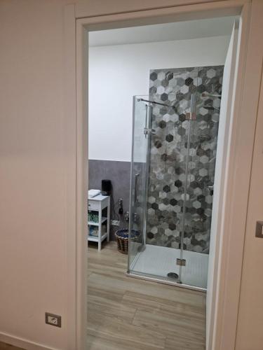 a shower with a glass door in a room at B&B Casa Tassoni in Maranello
