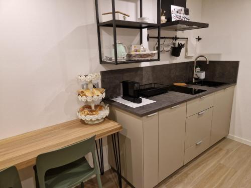 a small kitchen with a counter and a table at B&B Casa Tassoni in Maranello
