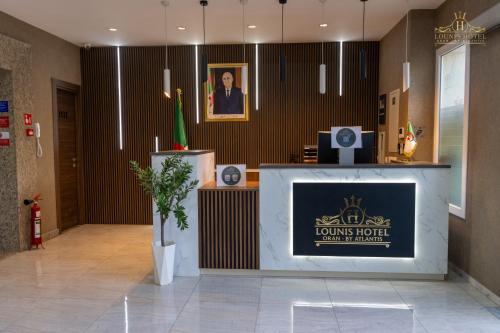 a lobby with a podium with a sign for a lions hotel at Lounis Hôtel by Atlantis in Oran