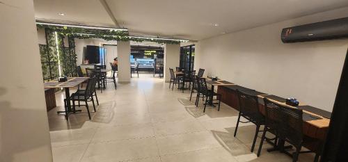a restaurant with tables and chairs in a room at #FLAT425 Get One - João Pessoa - Brasil in João Pessoa