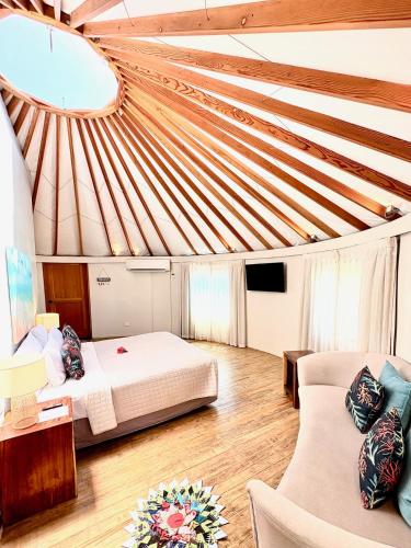 a large room with a bed and a couch at Blue Lagoon Beach Resort in Nacula Island