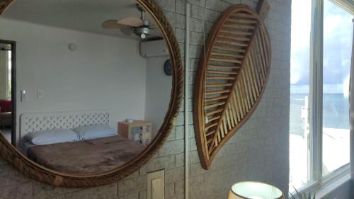 a bedroom with a large mirror on the wall at Apartamentos Commodore Bay Club in San Andrés