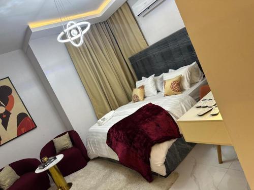 a hotel room with a bed and a desk and a bedroom at RGS Luxury Residence in Ibadan