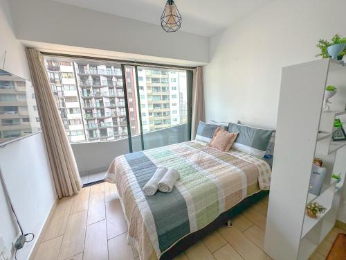 a bedroom with a bed and a large window at Nuevo departamento exclusivo a un paso de San Isidro in Lima