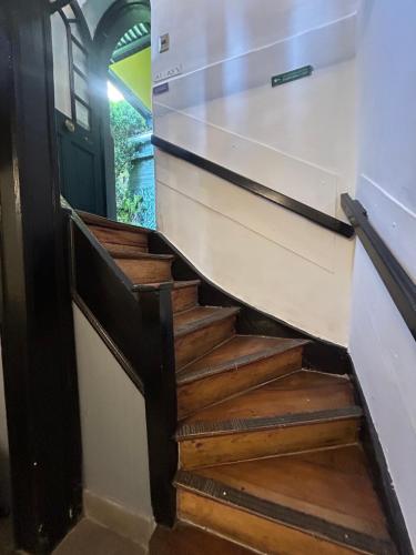 a set of stairs in a house with a door at De Blasis Budget Rooms in Santiago