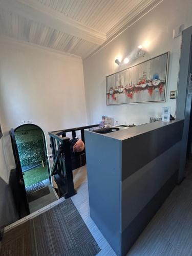 a kitchen with a counter and a stairway at De Blasis Budget Rooms in Santiago