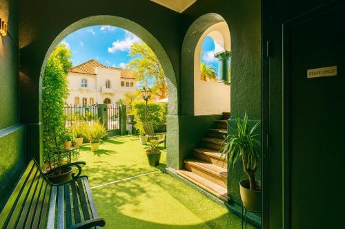 a view of a house from a hallway with a bench at De Blasis Budget Rooms in Santiago