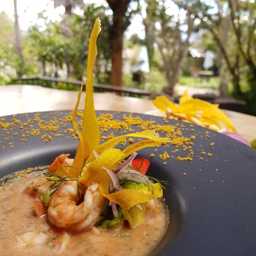a plate of food with shrimp and vegetables on it at Hacienda Jimenita Wildlife Reserve in Puembo