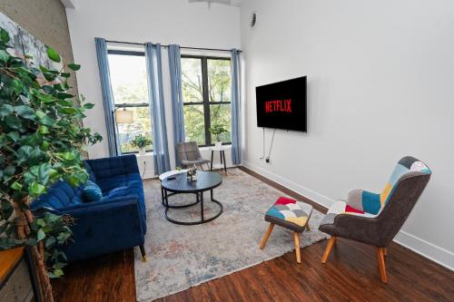 a living room with a blue couch and chairs at South Loop 3BR Group Comfort Near Downtown, Grant Park, Soldier Field and McCormick Place in Chicago