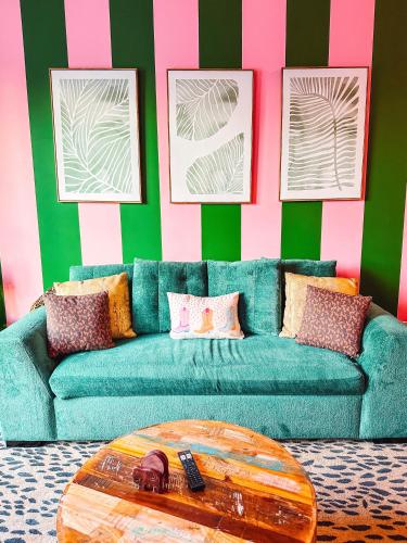 a living room with a blue couch and a table at Dreaming With Dolly - Luxe Stay Near Broadway in Nashville
