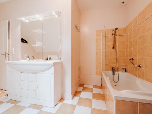 a bathroom with a sink and a tub and a shower at Gîte cosy en Berry avec jardin et parking, proche de Châteauroux, pour 10 personnes - FR-1-591-31 in Arthon