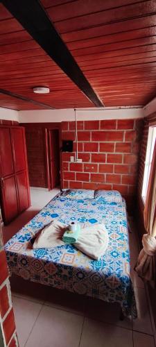 a person laying on a bed in a room at Hotel y restaurante juanchito in Pitalito