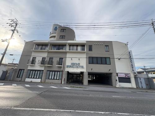 a large white building with aventh floor at 彦根びわこホテル裏のマンション 一室貸し切り50台無料駐車場付き台所あり自転車貸出可 BbQ可 ペット同伴可 in Hikone