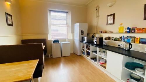 a kitchen with a counter and a refrigerator at Railway Inn in Buckhaven
