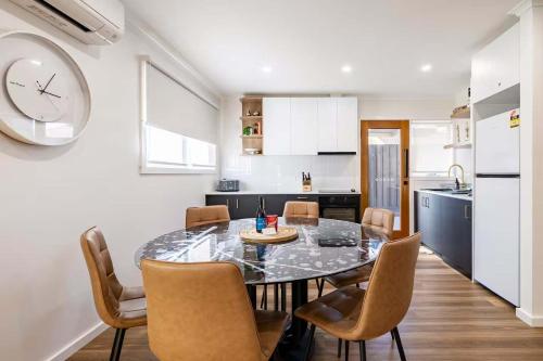 a kitchen and dining room with a table and chairs at Ocean Gioia - Stroll to shops and beach in Ocean Grove
