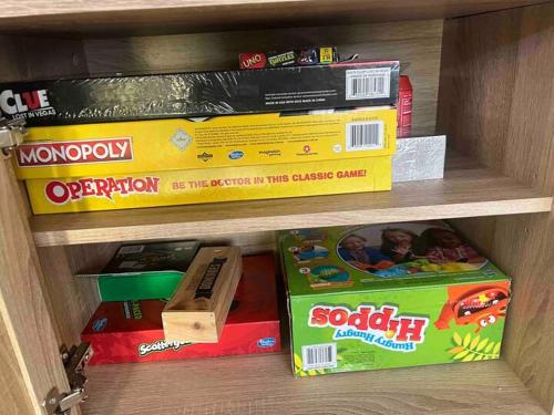 a stack of toy boxes on a shelf at Ocean Gioia - Stroll to shops and beach in Ocean Grove