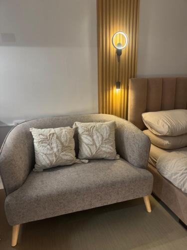 a couch with pillows on it in a room at CDO Nest in Cagayan de Oro
