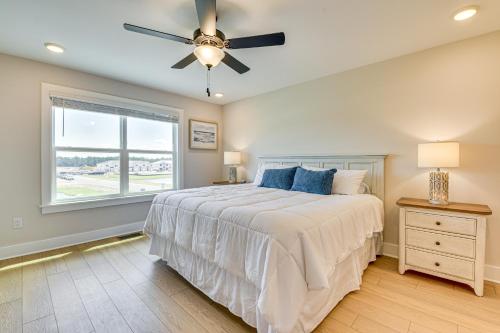 a bedroom with a bed with a ceiling fan and a window at Easy Beach Access New PCB Retreat with Resort Pool! in Panama City Beach