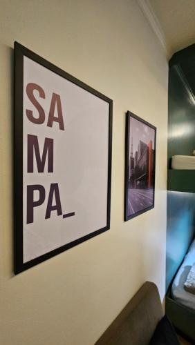 a sign on a wall with a picture on it at Hostel new way in Sao Paulo
