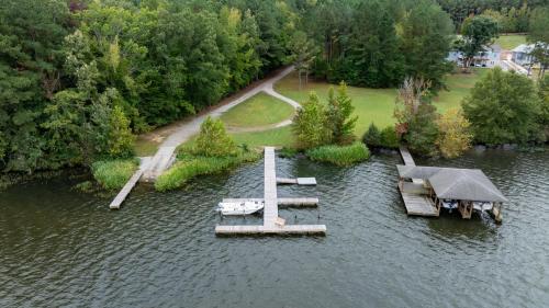 an aerial view of a dock in the water at Cozy Lake Getaway with Firepit, Lake Access, Theatre in Boydton