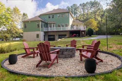 a group of chairs sitting in front of a house at Cozy Lake Getaway with Firepit, Lake Access, Theatre in Boydton